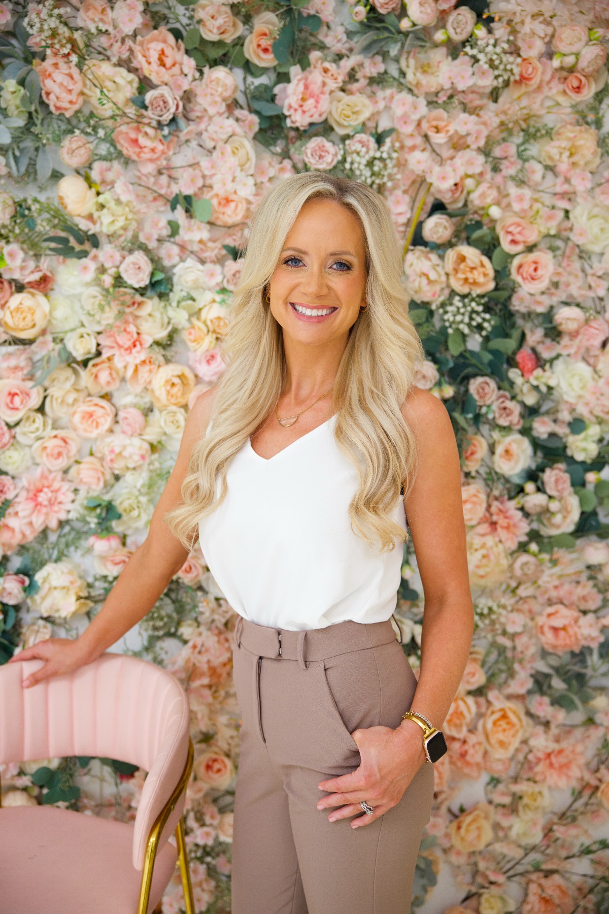 Brittany Stanley standing by a floral wall — the promise behind Vellvé.